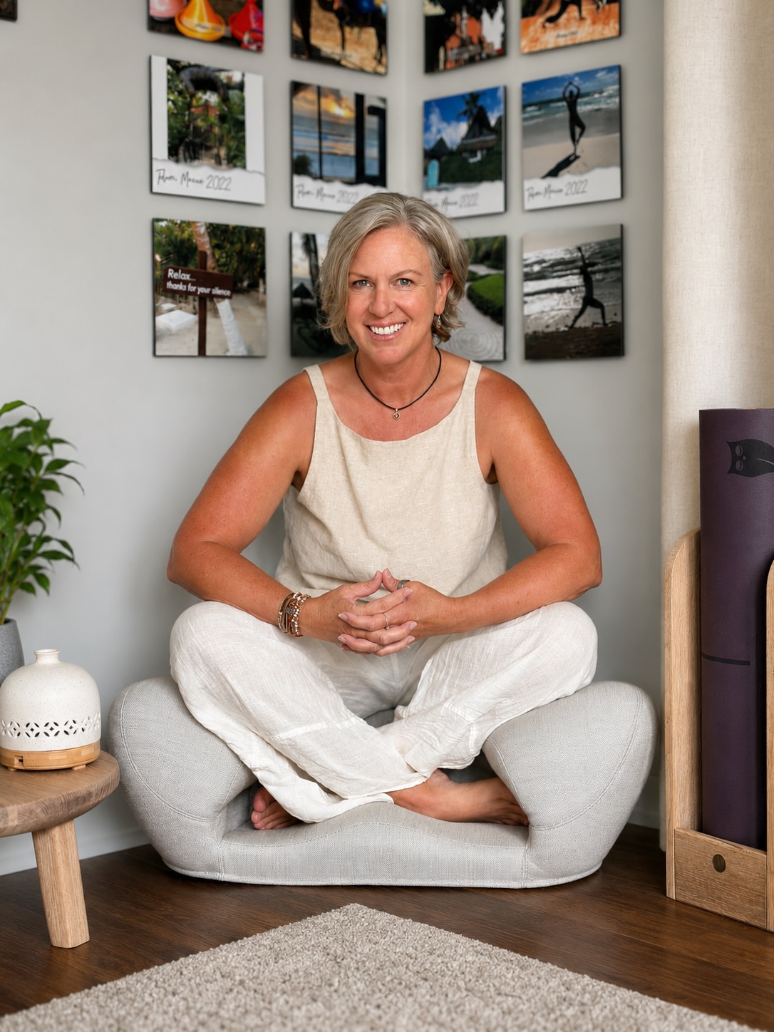 LoriAnn seated cross-legged in her home practice space